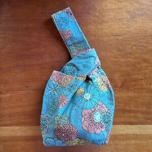 Maruca USA blue/peach floral tapestry origami wrist bag/purse